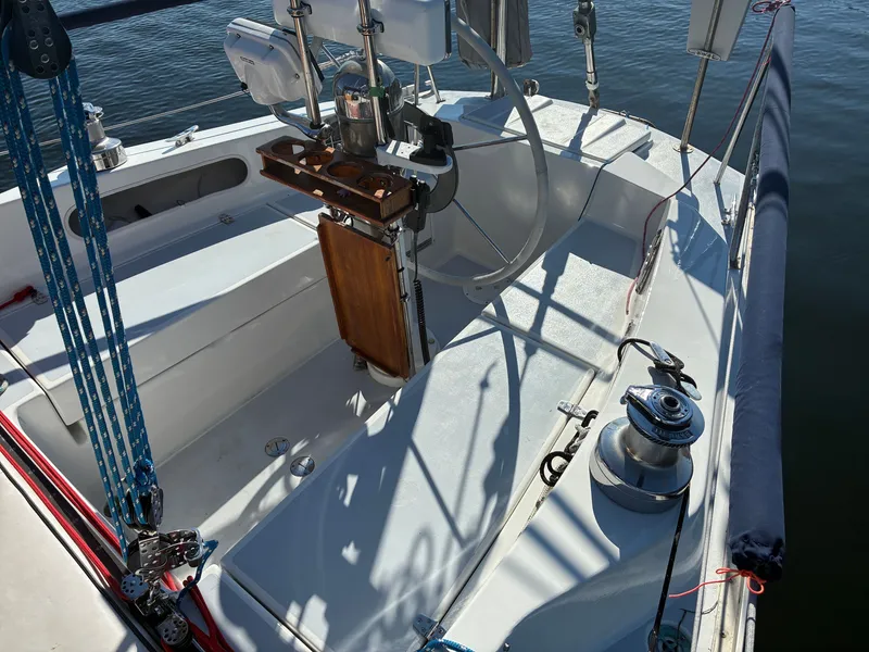 Slide: The Image of The cockpit of a 1973 Pearson 36 with a steering wheel and sailing equipment. - 17