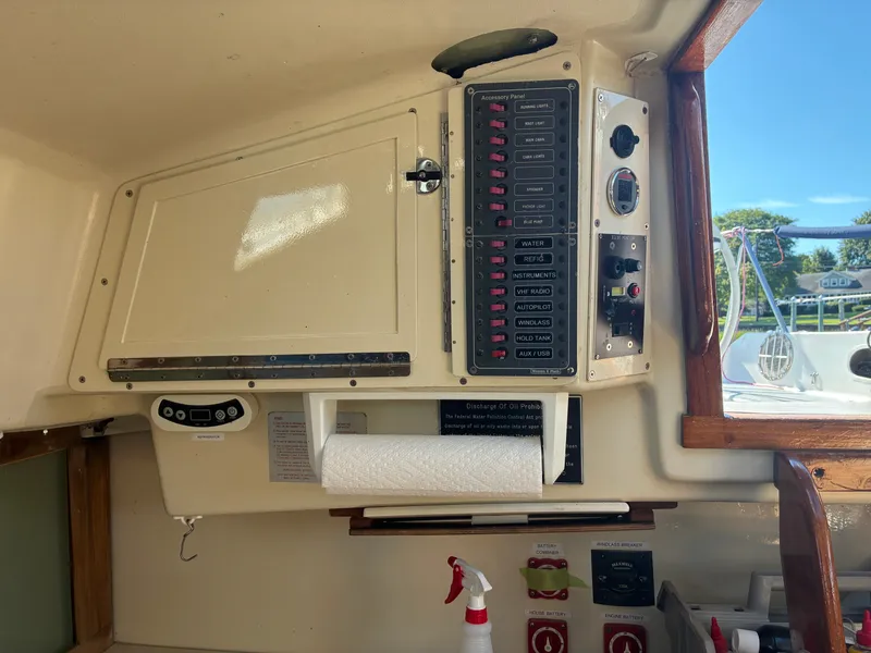 Slide: The Image of The image shows the cockpit of a 1973 Pearson 36 with a control panel and paper towel holder. - 34