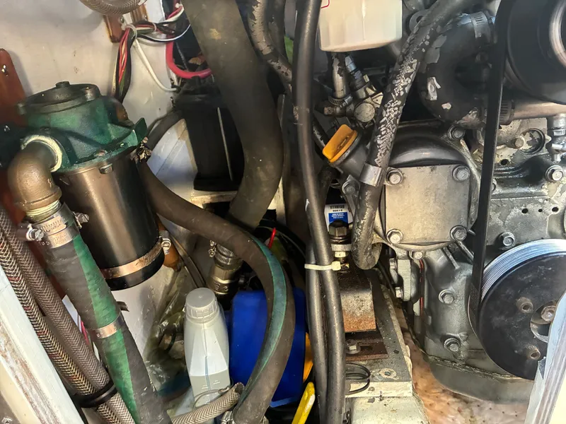 Slide: The Image of Close-up of a 1973 Pearson 36 engine compartment with hoses and mechanical parts. - 42