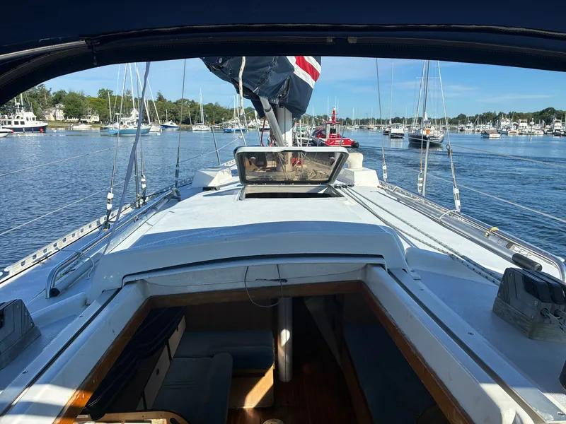 Slide: The Image of View from the cockpit of a 1973 Pearson 36 overlooking a calm harbor. - 26