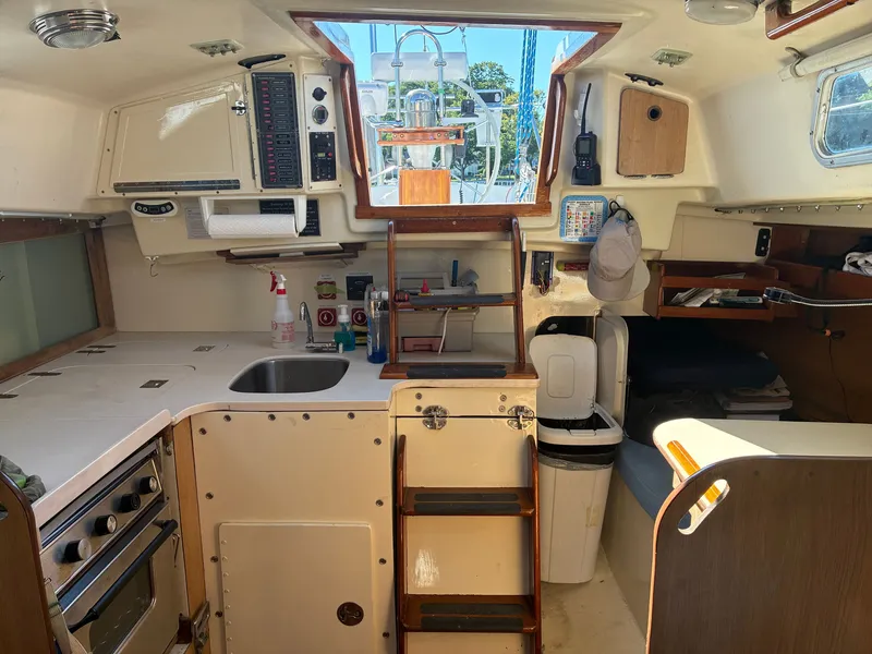 Slide: The Image of Interior of a 1973 Pearson 36 with kitchen, sink, and storage space. - 31