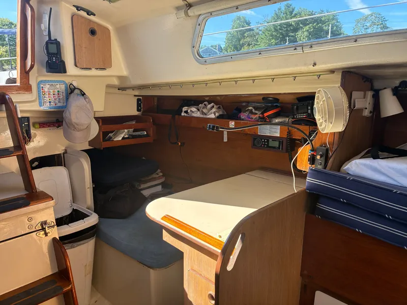 Slide: The Image of Interior of a 1973 Pearson 36 sailboat featuring a cozy salon and navigation equipment. - 35