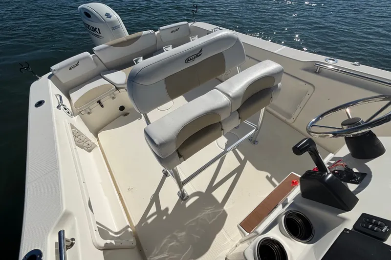 Slide: The Image of 2019 Bulls Bay 230 Center Console boat interior with seating and steering wheel. - 11