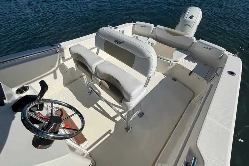 Slide: The Image of 2019 Bulls Bay 230 Center Console boat interior with steering wheel and seating. - 10