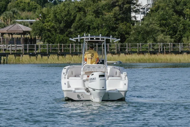 Slide: The Image of 2019 Bulls Bay 230 Center Console boat cruising on a scenic waterway. - 2
