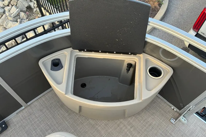 Slide: The Image of 2025 Sun Tracker Fishin' Barge 20 DLX livewell with cup holder and storage compartments. - 18