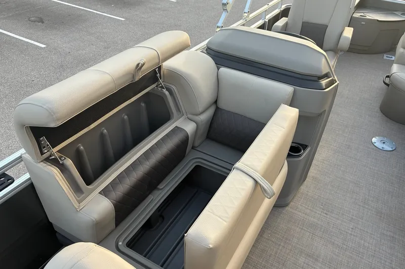 Slide: The Image of 2025 Sun Tracker Fishin' Barge 20 DLX interior with open storage compartments and seating. - 16