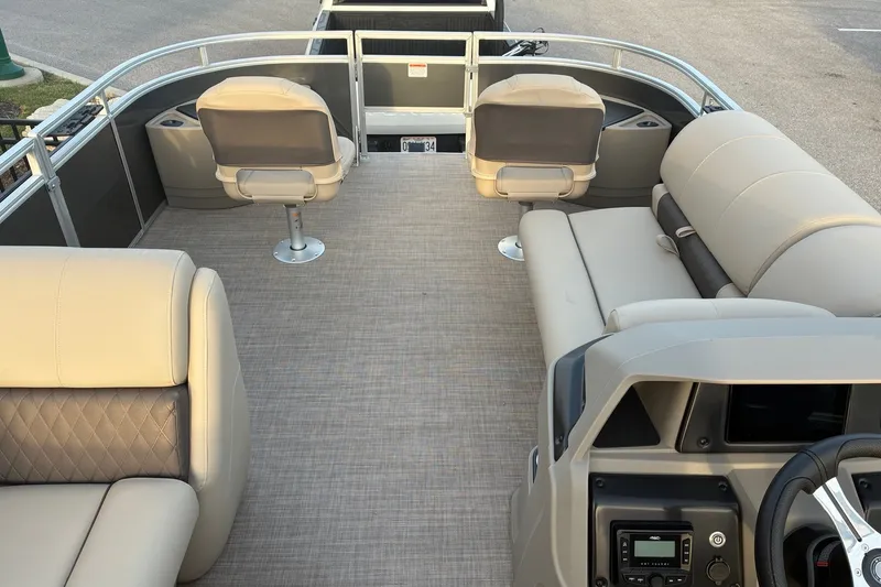 Slide: The Image of 2025 Sun Tracker Fishin' Barge 20 DLX interior with seating and helm. - 14