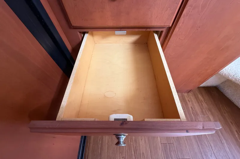 Slide: The Image of Open wooden cabinet inside 2004 Silverton 43 Motor Yacht, showcasing interior storage space. - 95
