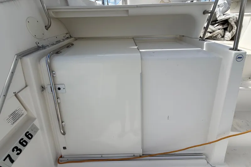 Slide: The Image of 2004 Silverton 43 Motor Yacht deck area with storage compartment and railing. - 78