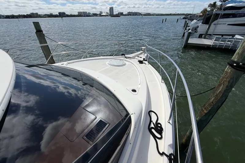 Slide: The Image of 2004 Silverton 43 Motor Yacht docked, reflecting sky and water views. - 47