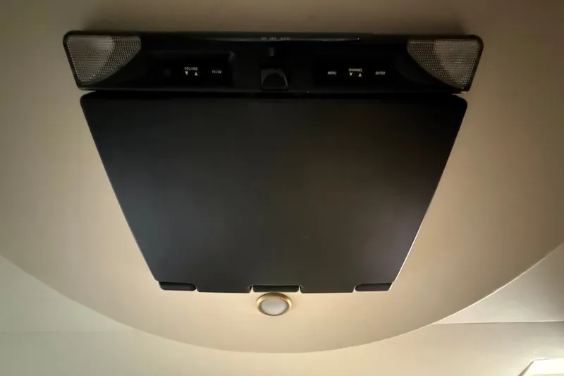 Slide: The Image of Ceiling-mounted TV screen in a 2004 Silverton 43 Motor Yacht interior. - 166