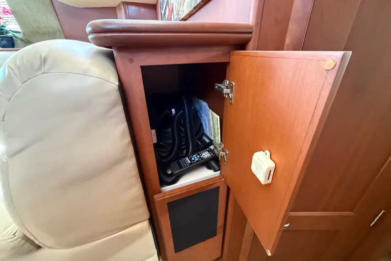 Slide: The Image of Cabinet storage inside 2004 Silverton 43 Motor Yacht with communication equipment. - 112
