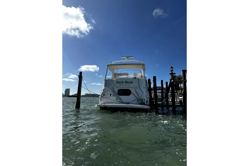 Slide: The Image of 2004 Silverton 43 Motor Yacht docked on a sunny day, clear blue sky. - 2