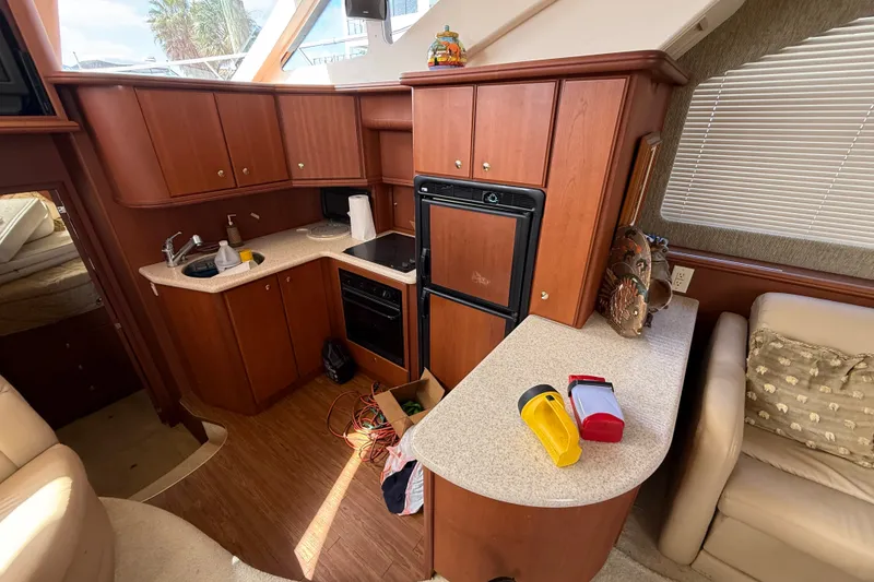 Slide: The Image of Interior of 2004 Silverton 43 Motor Yacht kitchen with wooden cabinets and appliances. - 89