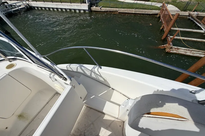 Slide: The Image of 2004 Silverton 43 Motor Yacht deck view with railing and water backdrop. - 42