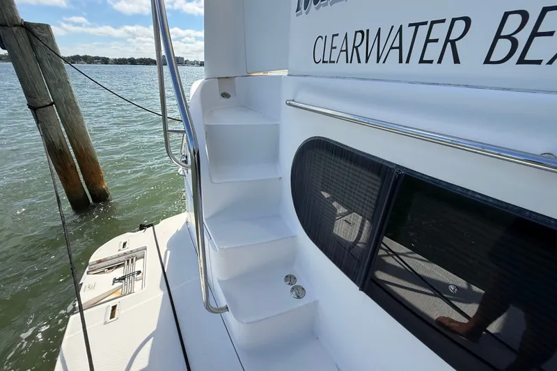Slide: The Image of 2004 Silverton 43 Motor Yacht docked at Clearwater Beach, featuring sleek white stairs. - 5