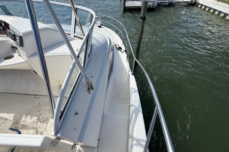 Slide: The Image of 2004 Silverton 43 Motor Yacht docked, showcasing deck and railing details. - 43