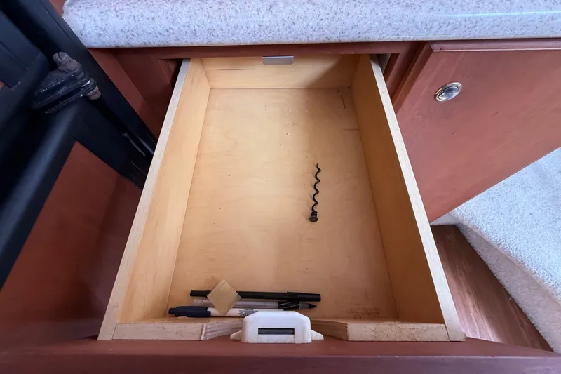 Slide: The Image of Open drawer in 2004 Silverton 43 Motor Yacht with corkscrew and miscellaneous items. - 93
