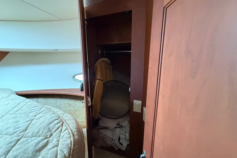 Slide: The Image of Interior of 2004 Silverton 43 Motor Yacht showing a closet and bed. - 128