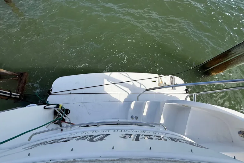 Slide: The Image of 2004 Silverton 43 Motor Yacht docked, view from stern over water. - 76