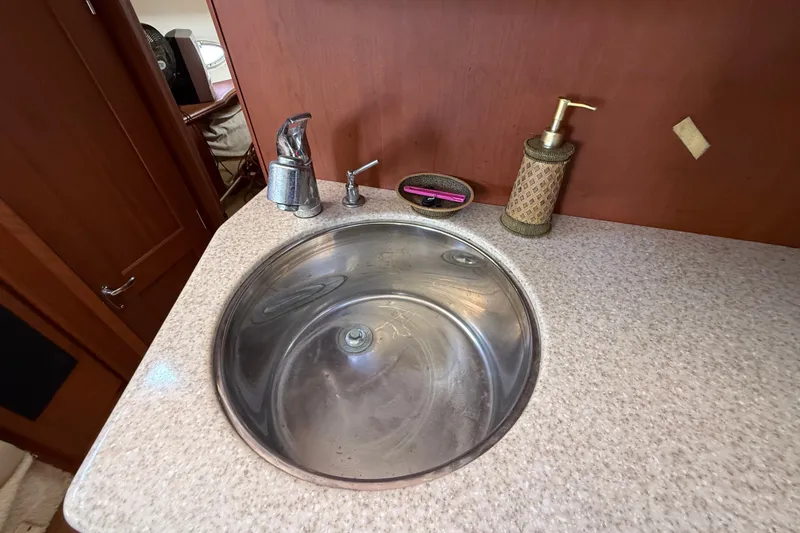 Slide: The Image of Stainless steel sink in 2004 Silverton 43 Motor Yacht bathroom with soap dispenser. - 109