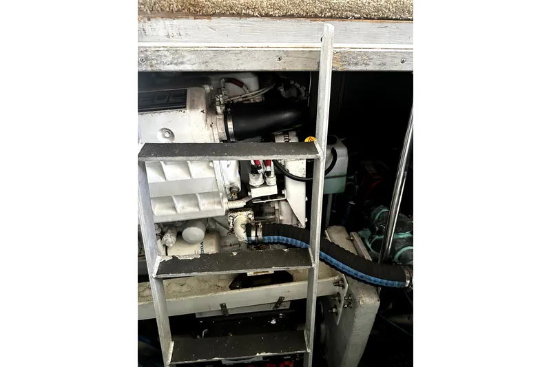 Slide: The Image of Engine compartment of a 2004 Silverton 43 Motor Yacht with visible machinery and ladder. - 21