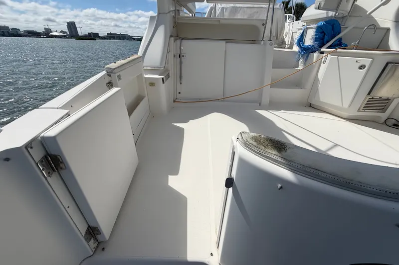 Slide: The Image of 2004 Silverton 43 Motor Yacht deck with open storage, overlooking waterfront. - 7