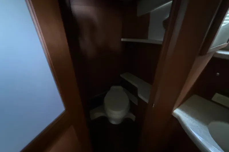 Slide: The Image of 2004 Silverton 43 Motor Yacht bathroom interior with wooden cabinetry and toilet. - 152