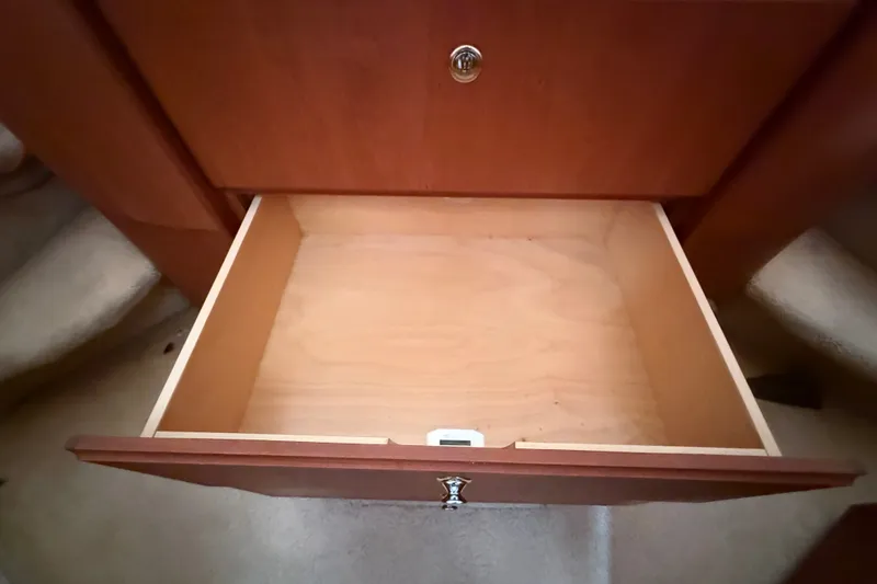 Slide: The Image of Open wooden drawer inside 2004 Silverton 43 Motor Yacht, showcasing interior storage space. - 123