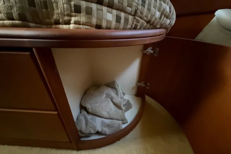 Slide: The Image of Open cabinet in 2004 Silverton 43 Motor Yacht with towels inside. - 159