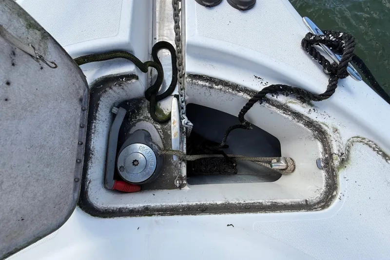 Slide: The Image of Anchor compartment of a 2004 Silverton 43 Motor Yacht with ropes and winch. - 52