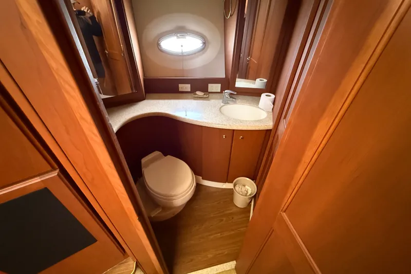 Slide: The Image of Luxurious bathroom in 2004 Silverton 43 Motor Yacht with wood cabinetry and modern fixtures. - 114