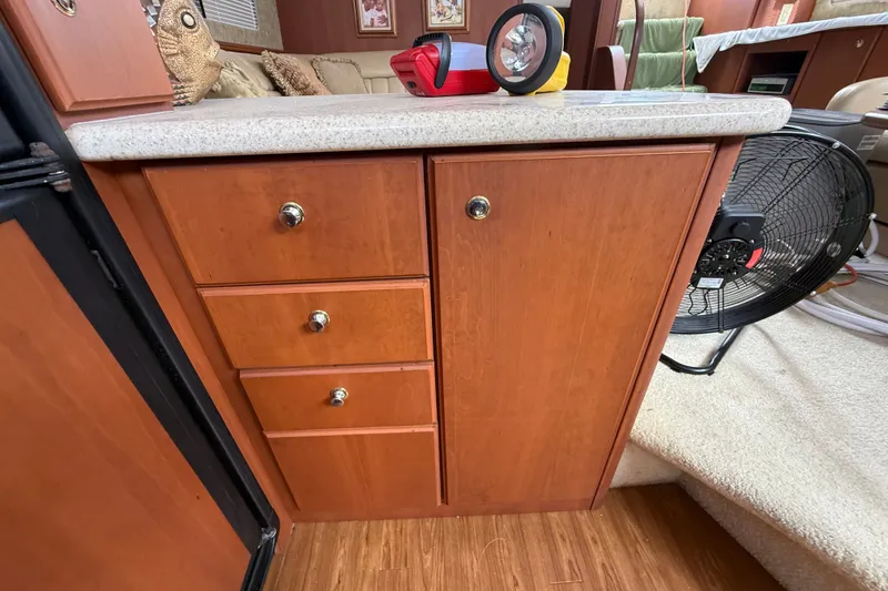 Slide: The Image of 2004 Silverton 43 Motor Yacht interior with wooden cabinetry and countertop. - 92