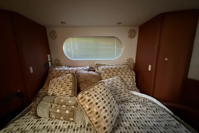 Slide: The Image of Luxurious cabin interior of 2004 Silverton 43 Motor Yacht with plush bedding. - 161