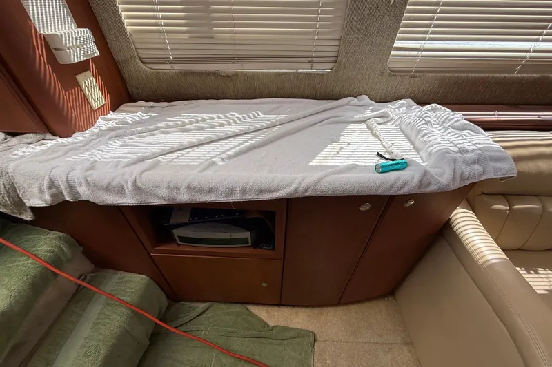Slide: The Image of Interior of a 2004 Silverton 43 Motor Yacht with towel-covered cabinet and tools. - 83