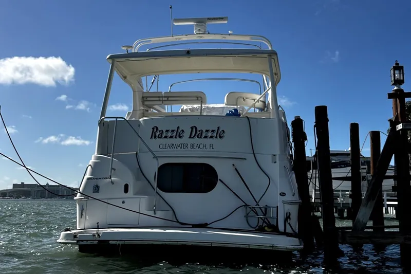 Slide: The Image of 2004 Silverton 43 Motor Yacht docked on a sunny day, clear blue sky. - 2