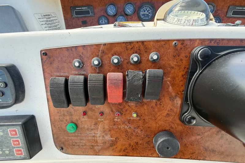 Slide: The Image of Control panel of a 2004 Silverton 43 Motor Yacht with switches and gauges. - 35