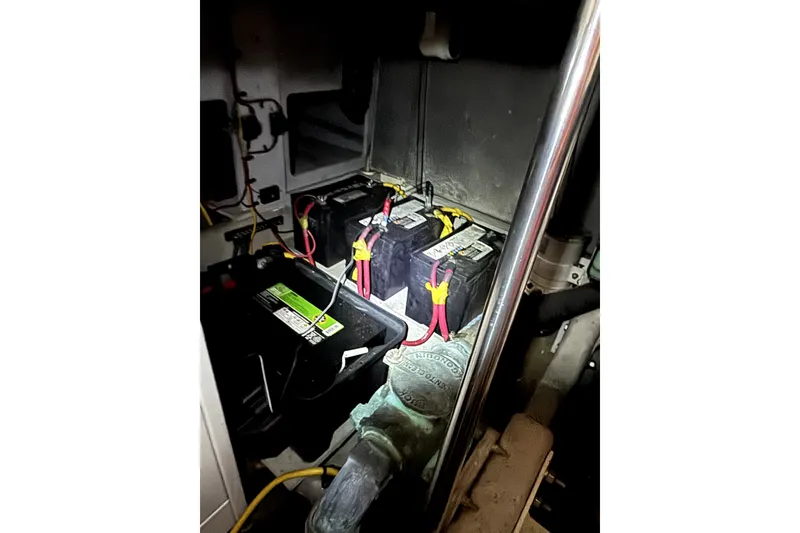 Slide: The Image of Battery compartment of a 2004 Silverton 43 Motor Yacht, featuring multiple connected batteries. - 20