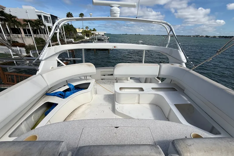 Slide: The Image of 2004 Silverton 43 Motor Yacht deck with seating, overlooking waterfront and residential area. - 67