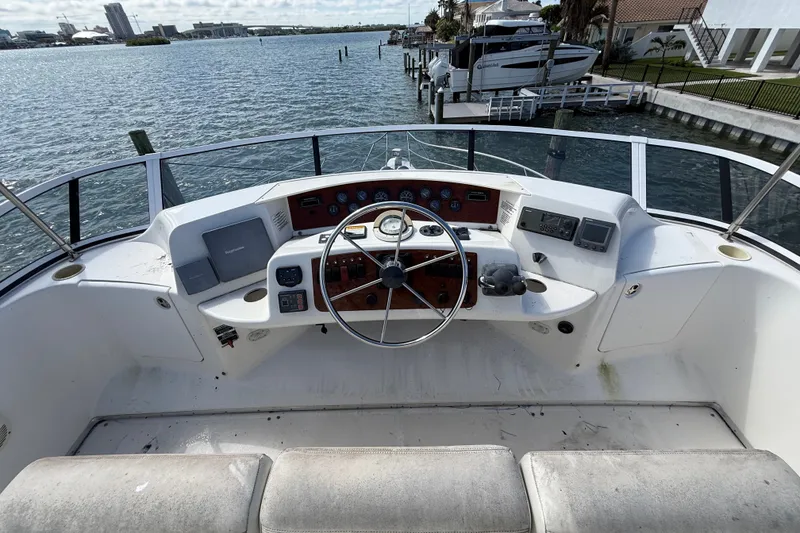Slide: The Image of 2004 Silverton 43 Motor Yacht helm with steering wheel and navigation controls. - 27