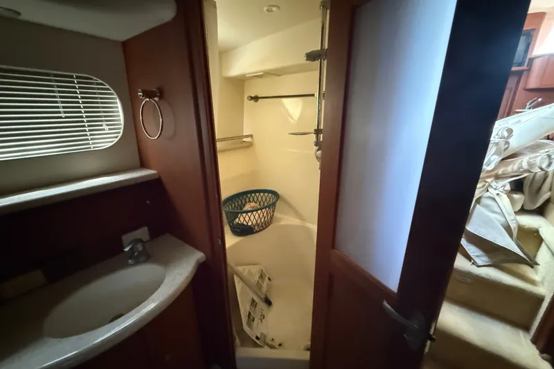 Slide: The Image of 2004 Silverton 43 Motor Yacht bathroom with sink, shower, and storage space. - 145