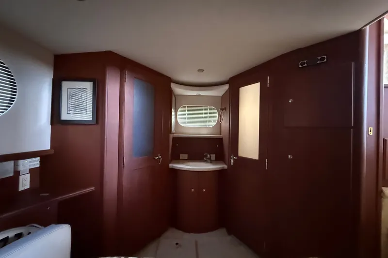 Slide: The Image of Interior of 2004 Silverton 43 Motor Yacht with wooden cabinetry and sink. - 142
