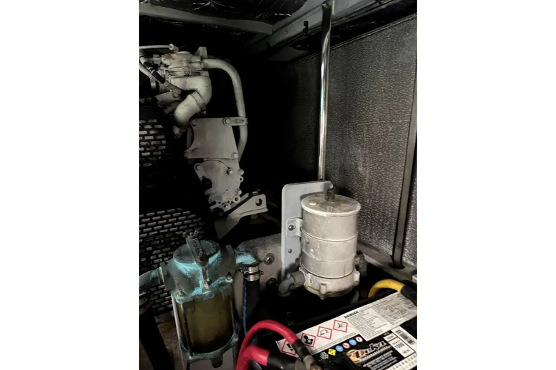 Slide: The Image of Engine compartment of a 2004 Silverton 43 Motor Yacht, showcasing mechanical components. - 17