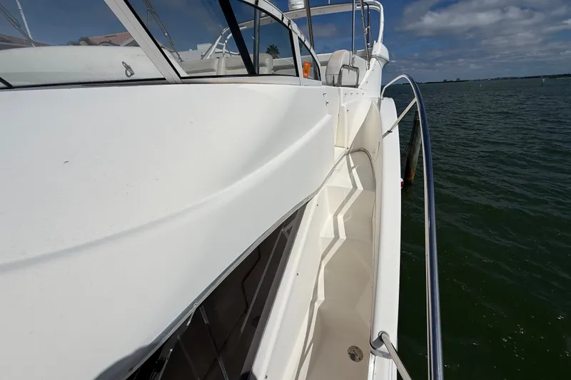 Slide: The Image of 2004 Silverton 43 Motor Yacht deck view with railing, overlooking calm waters. - 61