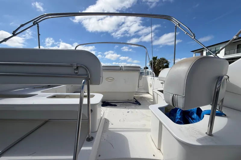 Slide: The Image of 2004 Silverton 43 Motor Yacht deck with seating under a clear blue sky. - 15