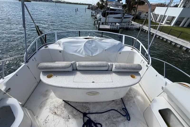 Slide: The Image of 2004 Silverton 43 Motor Yacht deck with seating, overlooking marina and waterfront homes. - 24