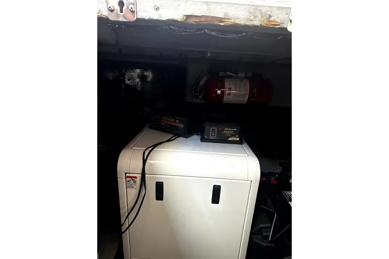 Slide: The Image of Engine room of 2004 Silverton 43 Motor Yacht with equipment and fire extinguisher. - 22