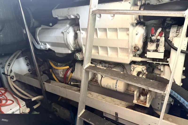Slide: The Image of Engine room of a 2004 Silverton 43 Motor Yacht, showcasing mechanical components and wiring. - 15