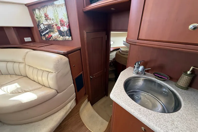 Slide: The Image of Interior of 2004 Silverton 43 Motor Yacht with sink, seating, and artwork. - 111